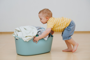 child pushing laundry physical therapy
